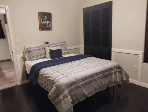 a bedroom with a bed with a blue blanket at Palo Duro in Alamogordo