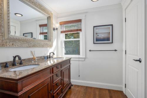 a bathroom with a sink and a mirror and a shower at 10 Seventh Street Harwich Cape Cod- -Cape Vista in Harwich