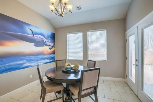 a dining room with a table and a whale painting at 817 Shiprock Spacious 5BD 3BATH near Golf Course in Alamogordo