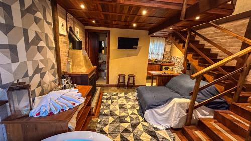 a room with a bunk bed and a staircase at CHALÉS LUAR DO PICO in Santo Antônio do Pinhal
