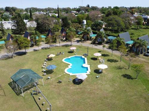 an aerial view of a park with a pool and umbrellas at Cabañas LAS PALMERAS in La Paz