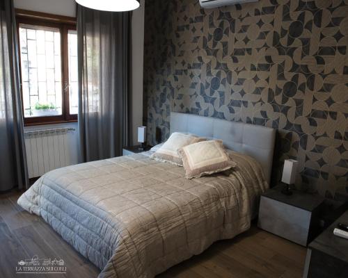 a bedroom with a bed and a stone wall at B&B La Terrazza sui Colli in Rome
