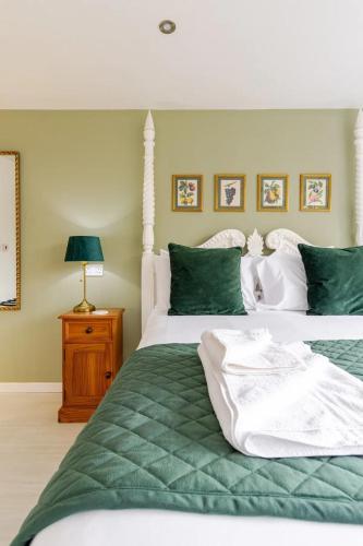 a bedroom with two beds with green and white at Stylish country apartment near Rookery Hall in Worleston