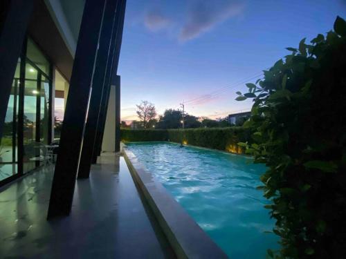 a swimming pool in a house with blue water at 501B #1km to central festival #5 km to lee garden in Ban Khlong Wa