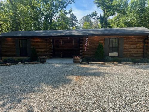 a log cabin with a flag in front of it at Cozy 1-Bedroom Retreat in Imperial