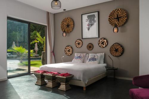 a bedroom with a bed and a large window at Villa Netumia in Marrakesh