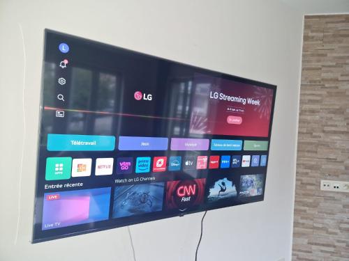 a large flat screen tv hanging on a wall at Luxe Bruxelles in Brussels
