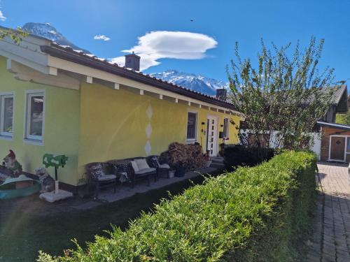 a yellow house with a cloud in the sky at Chalet Fini in Bramberg am Wildkogel