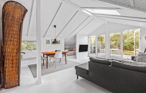 a living room with a couch and a table at Stunning Home In Gilleleje With Wifi in Gilleleje