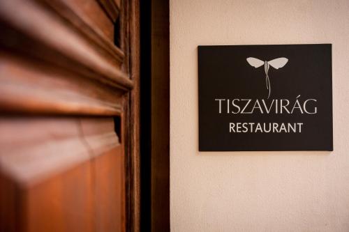 a picture on a wall with a sign on it at Tiszavirág Szeged in Szeged