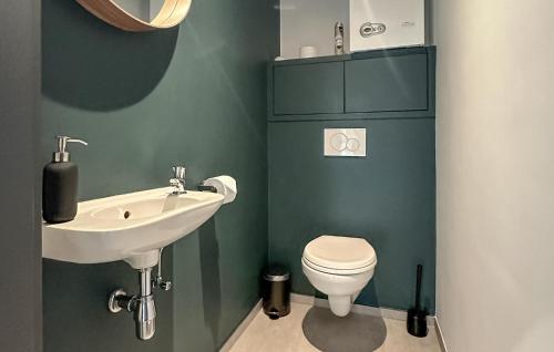 a bathroom with a sink and a toilet at 2 Bedroom Beautiful Apartment In Bièvre in Bièvre