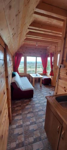 a large room with two beds and a table in it at Markove kolibe 5, Uvac, Sjenica in Sjenica