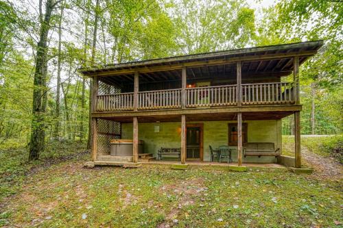 a cabin in the woods with a large deck at Chickasaw in Logan