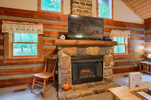 a living room with a fireplace and a television at Chickasaw in Logan