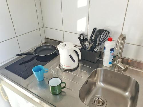 a kitchen counter top with a sink and a sink at Aparthotel B & L in Bremen