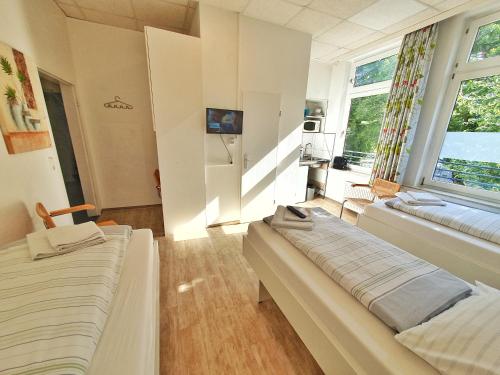a room with two beds and a window at Aparthotel B & L in Bremen