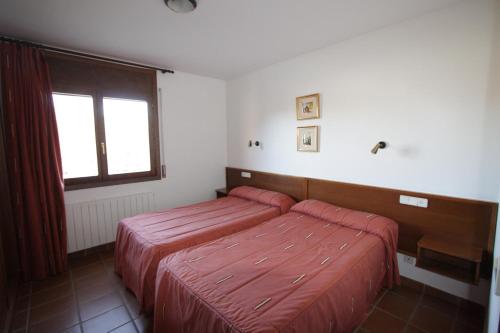 Ένα ή περισσότερα κρεβάτια σε δωμάτιο στο Apart-Hotel Selva Nevada