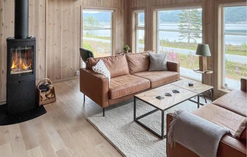 a living room with a couch and a fireplace at Lovely Home In Treungen in Fjone