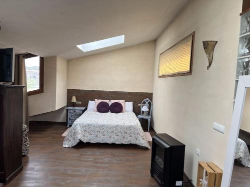 a bedroom with a bed with two pillows on it at Cal Fraguerau in Ulldemolins