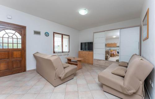 a living room with two chairs and a couch at Beach Front Apartment in Sveti Filip i Jakov