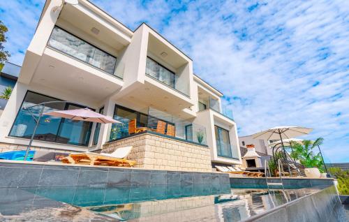 a large house with a swimming pool in front of it at Villa Grandiosa in Blato
