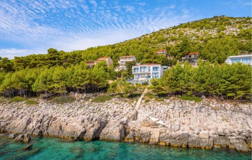 an island with houses on a rocky shore at Villa Grandiosa in Blato