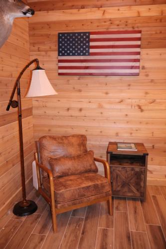an american flag on a wall with a chair and a lamp at Cozy Cabin Retreat for Your Perfect Getaway in Imperial