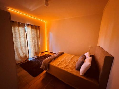 a bedroom with a bed with two pillows on it at Apartamento Poços de Caldas in Poços de Caldas