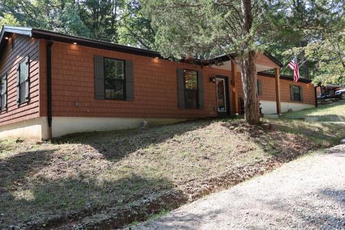 a small house with a tree in front of it at Cozy Cabin Retreat for Your Perfect Getaway in Imperial