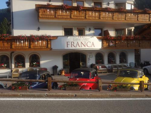 a group of cars parked in front of a hotel at Garni Franca b&b in Selva di Val Gardena