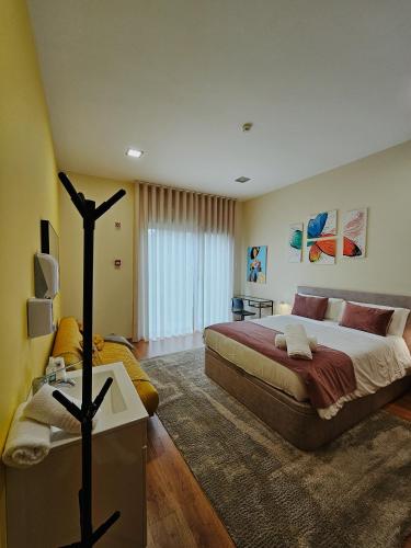 a bedroom with a king sized bed in a room at Junção - Apartamentos Completos in Miranda do Douro