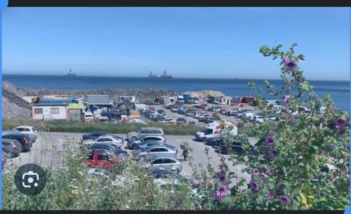 a bunch of cars parked in a parking lot near the ocean at Luxury Catalan Bay Beach House - Sea + Rock Views in Gibraltar