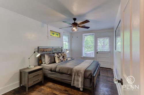 a bedroom with a bed and a ceiling fan at Hideaway Retreat in the Heart of Cooper Young in Memphis