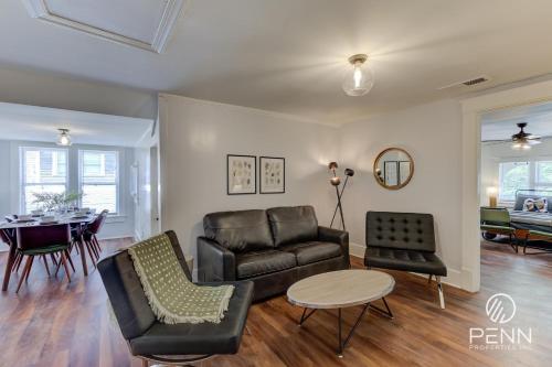 a living room with a couch and a table at Hideaway Retreat in the Heart of Cooper Young in Memphis