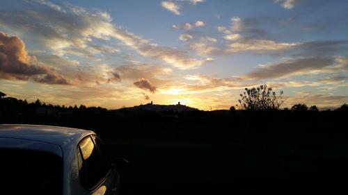 a car parked in front of a sunset at Hostal Rural La Plata Parking Incluido in Arcos de la Frontera