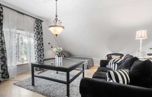 a living room with a black couch and a table at Lejl 51 in Skanderborg