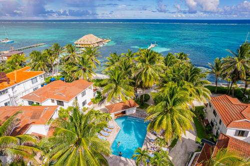an aerial view of a resort with palm trees and the ocean at Tradewinds Paradise Villas in San Pedro