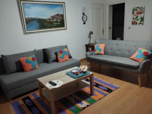 a living room with two couches and a coffee table at Apartamento Tui, Casa da Barca in Tui