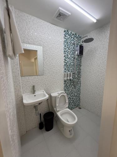 a bathroom with a toilet and a sink at Twenty Two Place Sukhumvit 22 in Bangkok