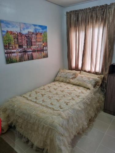 a bedroom with a bed and a window at Condo for Rent Cheer Residences in Marilao