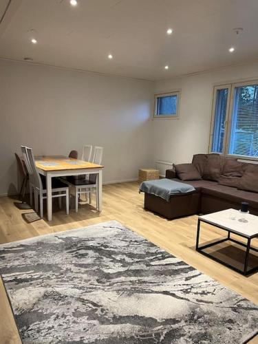 a living room with a couch and a table at Saukonkatu in Kokkola