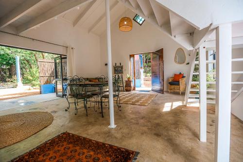 a living room with a table and chairs in it at Bamboo Cottage in Riebeek-Kasteel