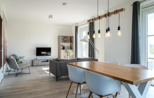 a living room with a wooden table and chairs at Cozy Apartment In Kamperland With Wifi in Kamperland