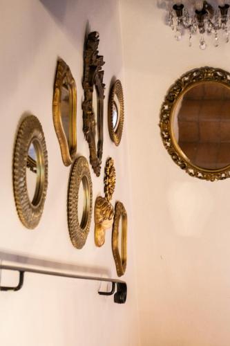 a group of gold frames hanging on a wall at L’Aurora in Todi