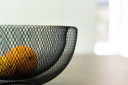 a black basket with an orange in it at Villa Lastva in Tivat