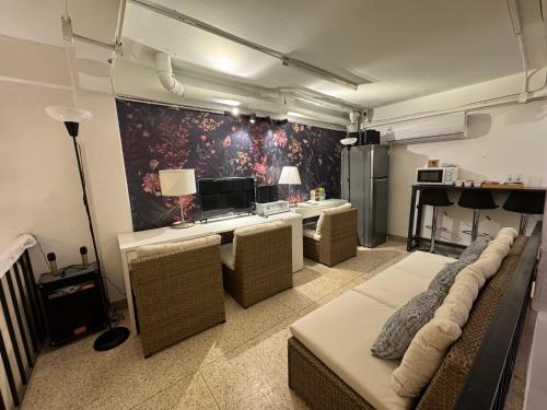 a room with couches and a table with a piano at Twenty Two Place Sukhumvit 22 in Bangkok