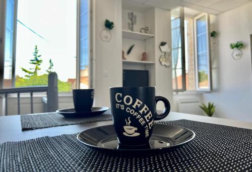 a coffee cup and a plate on a table at Myvi cognac in Cognac