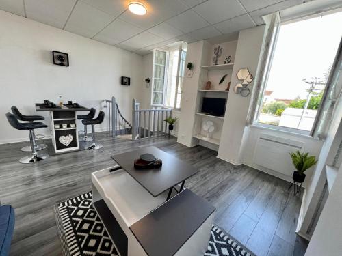 a large living room with a table and chairs at Myvi cognac in Cognac