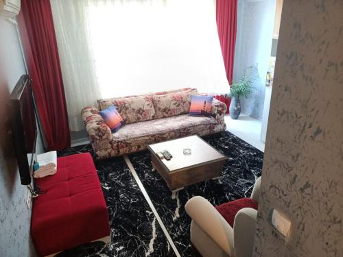 a living room with a couch and a table at Egepar Rezidance Apart otel in Buca
