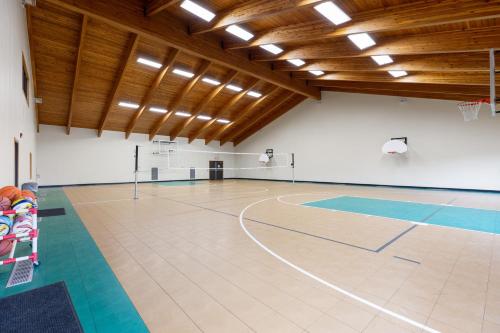 a gym with a basketball court in a building at The Lodges at Breezy Point in Breezy Point